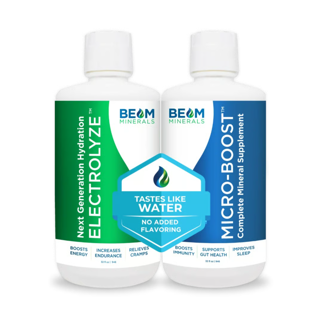 Two white BEAM Minerals supplement bottles with green and blue labels against a black background.
